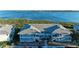 Two-story condo building featuring coastal blue siding and well-maintained landscaping near waterfront at 1153 Edgewater Cir, Bradenton, FL 34209