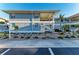 Two-story condo building with coastal blue siding, white accents, and well-maintained landscaping at 1153 Edgewater Cir, Bradenton, FL 34209