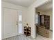Bright condo foyer featuring a white front door, gray wood floors, and a view into the living area at 1153 Edgewater Cir, Bradenton, FL 34209