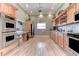 Spacious kitchen featuring stainless steel appliances, custom cabinetry, and wood flooring at 1153 Edgewater Cir, Bradenton, FL 34209