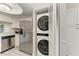 Kitchen area with stainless steel refrigerator and a stacked washer/dryer unit at 1153 Edgewater Cir, Bradenton, FL 34209