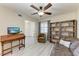 Bright living room features a desk, chair, bookshelf, and view to the front door, plus a ceiling fan at 1153 Edgewater Cir, Bradenton, FL 34209