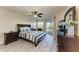 Bedroom with a ceiling fan, wood-look flooring, furniture, and sliding glass doors at 1153 Edgewater Cir, Bradenton, FL 34209