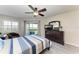 Bedroom with a ceiling fan, wood-look flooring, dresser, and sliding glass doors at 1153 Edgewater Cir, Bradenton, FL 34209
