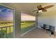 Cozy screened patio featuring views of lush greenery, a ceiling fan, and comfortable seating at 1153 Edgewater Cir, Bradenton, FL 34209