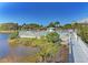 Scenic view of a community pool with a backdrop of lush greenery and a tranquil pond at 1153 Edgewater Cir, Bradenton, FL 34209