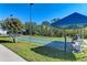 Community shuffleboard courts and shading with mature landscaping and benches to relax on at 1153 Edgewater Cir, Bradenton, FL 34209