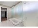 Bright bathroom features a large soaking tub with marble surround and glass partition at 1155 N Gulfstream Ave # 1709, Sarasota, FL 34236