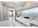 Bright bathroom featuring dual vanities with stone countertops and modern fixtures, adjacent to a glass-enclosed shower at 1155 N Gulfstream Ave # 1709, Sarasota, FL 34236