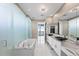 Modern bathroom with a large soaking tub and separate shower, complemented by dual vanities and sleek fixtures at 1155 N Gulfstream Ave # 1709, Sarasota, FL 34236