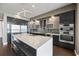Sleek, modern kitchen featuring stainless steel appliances, an island, and custom cabinetry at 1155 N Gulfstream Ave # 1709, Sarasota, FL 34236