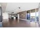 Spacious living room features dark hardwood floors and modern lighting fixtures with an attached kitchen at 1155 N Gulfstream Ave # 1709, Sarasota, FL 34236