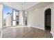 Bright living room with hardwood floors, floor to ceiling windows, and modern lighting fixtures at 1155 N Gulfstream Ave # 1709, Sarasota, FL 34236