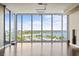 Spacious living room featuring floor to ceiling windows offering a beautiful view of the water and marina at 1155 N Gulfstream Ave # 1709, Sarasota, FL 34236