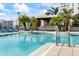 A poolside bar is surrounded by palm trees, offering a scenic view of a modern condo at 1155 N Gulfstream Ave # 1709, Sarasota, FL 34236