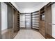 Organized walk-in closet featuring custom shelving, drawers, and ample storage space with a built-in safe at 1155 N Gulfstream Ave # 1709, Sarasota, FL 34236