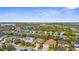 A picturesque neighborhood showcases well-maintained homes, complemented by tranquil lakes and lush greenery from an aerial perspective at 11603 Gramercy Park Ave, Bradenton, FL 34211