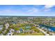 Picturesque aerial view showcasing parks, playgrounds, tennis courts, and scenic ponds within a community at 11603 Gramercy Park Ave, Bradenton, FL 34211