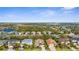 Panoramic view of a charming neighborhood with lush landscaping, community lakes, and beautiful well-maintained homes from an aerial perspective at 11603 Gramercy Park Ave, Bradenton, FL 34211