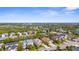 A scenic aerial showcases a well-planned residential area, featuring tree-lined streets, community lakes, and beautiful homes at 11603 Gramercy Park Ave, Bradenton, FL 34211