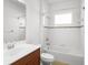 Bright bathroom featuring a shower-tub combo and wood-trimmed vanity with sink at 11603 Gramercy Park Ave, Bradenton, FL 34211