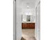 Dual-sink vanity in a bathroom with tiled floors and walk-in closet doors at 11603 Gramercy Park Ave, Bradenton, FL 34211