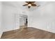 Serene bedroom space with hardwood floors, a ceiling fan and french doors providing an open and airy atmosphere at 11603 Gramercy Park Ave, Bradenton, FL 34211