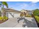 Stunning home featuring a three-car garage and manicured landscaping, and inviting curb appeal at 11603 Gramercy Park Ave, Bradenton, FL 34211