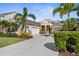 Beautiful single Gathering home with a two-car garage, manicured lawn, and lush tropical landscaping at 11603 Gramercy Park Ave, Bradenton, FL 34211