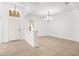 Bright foyer with chandelier lighting, tile flooring, and a half wall at 11603 Gramercy Park Ave, Bradenton, FL 34211
