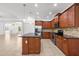 Beautiful kitchen with tile floor, stainless steel appliances, ample storage and central island with seating at 11603 Gramercy Park Ave, Bradenton, FL 34211