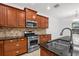 Updated kitchen with dark countertops, stainless steel appliances and ample wooden cabinetry and tiled backsplash at 11603 Gramercy Park Ave, Bradenton, FL 34211