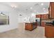 Bright kitchen boasting a functional island, stainless appliances, and a seamless flow into the home's living spaces at 11603 Gramercy Park Ave, Bradenton, FL 34211