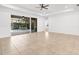 Spacious living room with tile flooring, recessed lighting, and sliding glass doors to the screened lanai and pool at 11603 Gramercy Park Ave, Bradenton, FL 34211