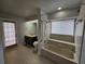 Updated bathroom with tile flooring, vanity, bath and shower, and sliding door at 1211 Peridot Lane, Sun City Center, FL 33573