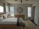 Cozy bedroom features a comfortable bed, dresser, and plenty of natural light from multiple windows at 1211 Peridot Lane, Sun City Center, FL 33573