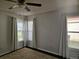 Sunlit bedroom features plush carpeting and plenty of natural light from multiple windows at 1211 Peridot Lane, Sun City Center, FL 33573