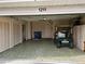 Garage space with a golf cart, storage, and access to the home's front door at 1211 Peridot Lane, Sun City Center, FL 33573