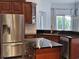 Well-appointed kitchen featuring stainless steel appliances, dark cabinets, and granite countertops with island at 1211 Peridot Lane, Sun City Center, FL 33573