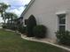 Professionally landscaped yard featuring lush plants, palms, decorative rocks, and a beautiful view at 1211 Peridot Lane, Sun City Center, FL 33573