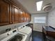 Functional laundry room with washer, dryer, and ample cabinet space for storage at 1211 Peridot Lane, Sun City Center, FL 33573