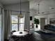 View of the living room and dining room with sleek black floors and view to the pool at 1211 Peridot Lane, Sun City Center, FL 33573