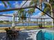 Inviting screened in pool area offers a serene view of the adjacent lake at 1211 Peridot Lane, Sun City Center, FL 33573