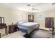 Comfortable bedroom with tile floors, ceiling fan, and ample storage at 1216 Yawl Way, Venice, FL 34285