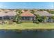 Aerial view of private backyard with screened in pool and water view at 13214 Treviso Dr, Bradenton, FL 34211