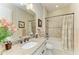 Well-lit bathroom featuring granite countertop, framed mirror, and shower with decorative curtain at 13214 Treviso Dr, Bradenton, FL 34211