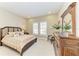Bedroom with large windows, accent pillows, side table, and classic decor at 13214 Treviso Dr, Bradenton, FL 34211