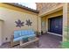 Cozy courtyard with wicker seating and decorative plants near the front door at 13214 Treviso Dr, Bradenton, FL 34211
