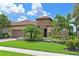 Beautiful single-Gathering home with lush landscaping, stone accents, and a barrel tile roof at 13214 Treviso Dr, Bradenton, FL 34211