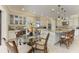 Gourmet kitchen with granite countertops, white cabinetry, stainless steel appliances, and a center island with bar seating at 13214 Treviso Dr, Bradenton, FL 34211